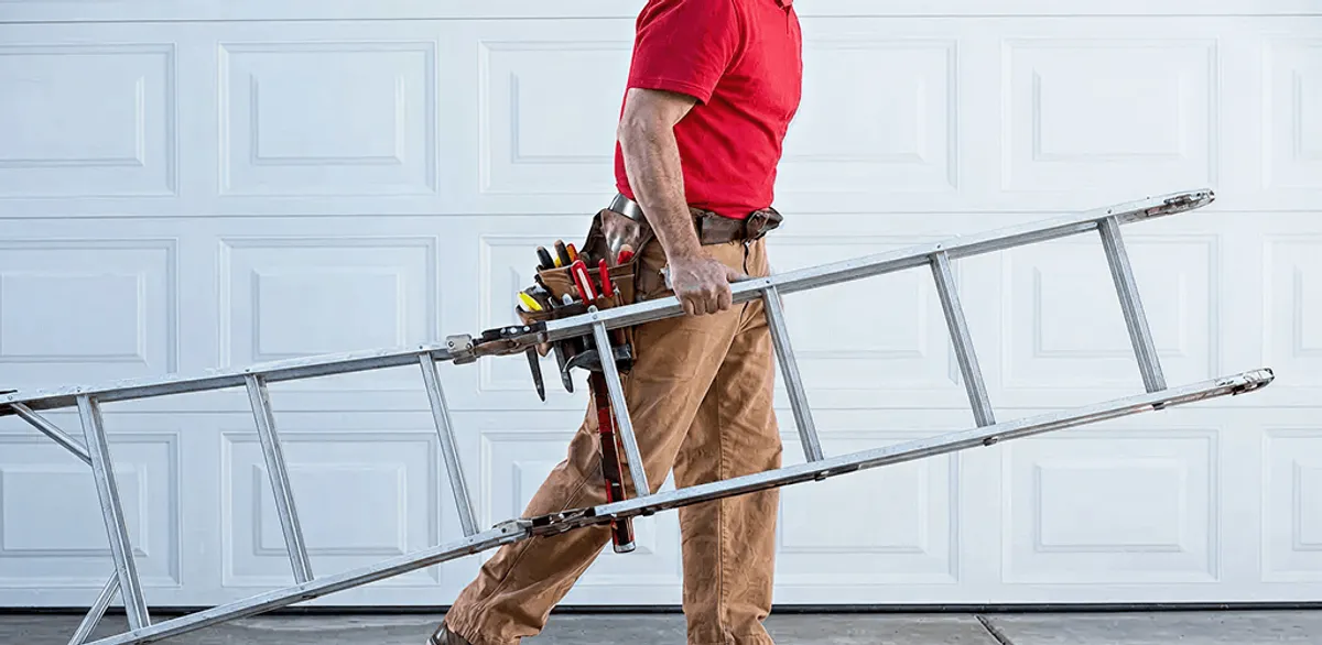 Garage door repair technician arriving with tools and ladder in Saint Louis, MO